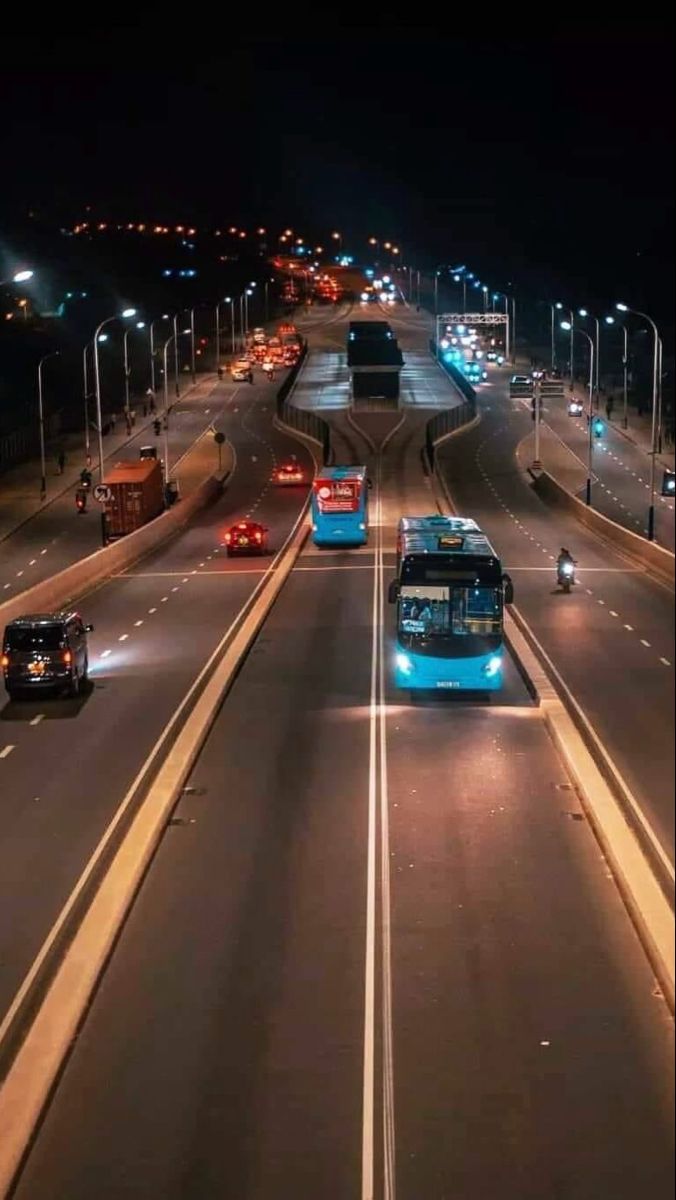 Dar es Salaam city highway at night with buses and traffic lights