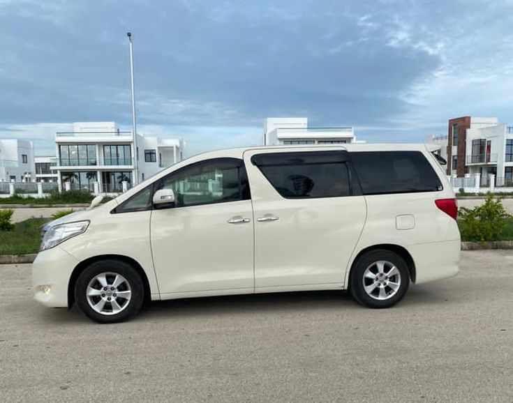 Private white transfer van outside a modern Zanzibar villa
